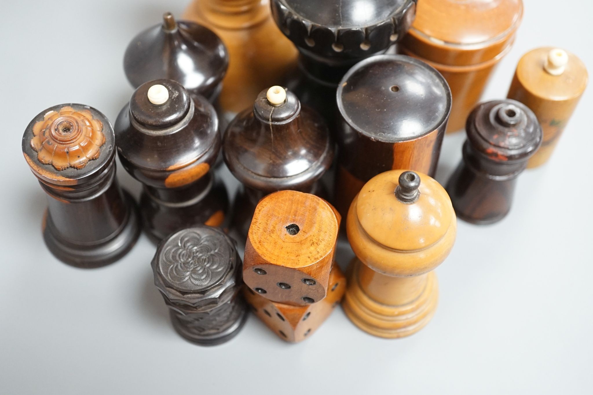 Nine Victorian turned or carved treen match holders with ‘go to bed’ finials, a treen double measure, cased glass measure and engine turned container (13)